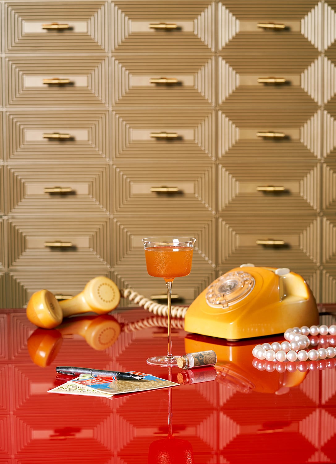 Signature cocktail with vintage rotary phone and pearls at Horatio bar, Resorts World Sentosa, Singapore