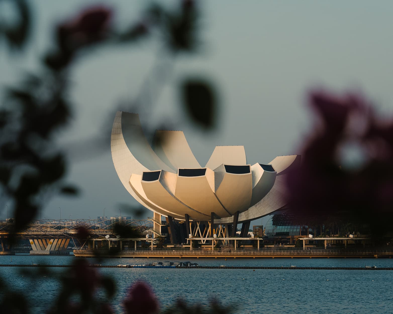 Close-up view of the ArtScience Museum lotus-shaped architecture at Marina Bay Sands with reflections on Marina Bay waters.