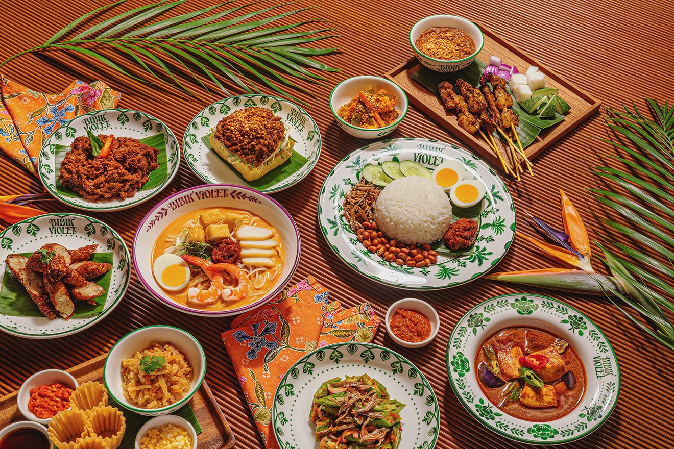 Traditional Peranakan dishes at Bibik Violet Singapore featuring nasi lemak, laksa, satay, and nyonya favourites in vintage-style serveware
