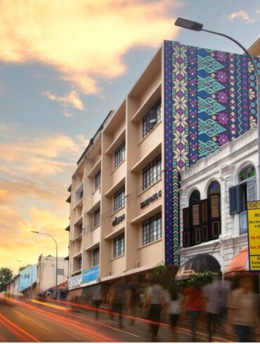 Exterior view of Coliwoo Hotel Kampong Glam in Singapore, featuring geometric facade inspired by traditional Malay textile patterns