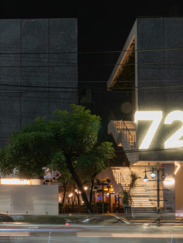 Night view of the modern concrete façade and illuminated “72” signage of 72 Courtyard Bangkok, a lifestyle and nightlife destination in Thonglor Thailand.