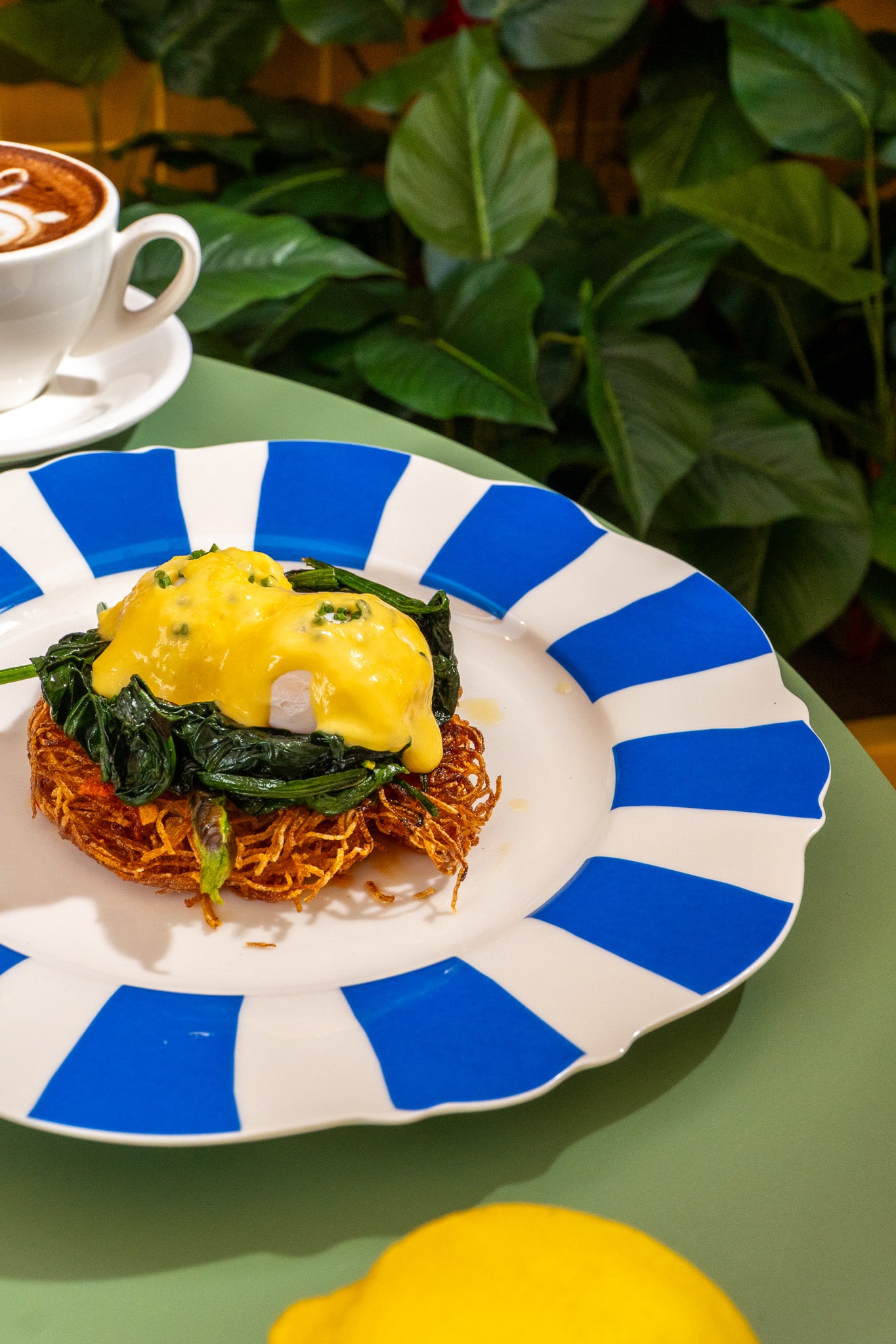 Aglio Olio Benedict on crispy hash brown with sautéed spinach at Fortuna Terrazza, an Amalfi-inspired brunch café in Tanjong Pagar, Singapore