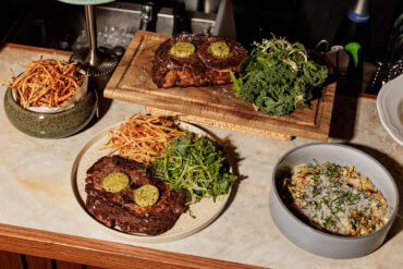 Grilled ribeye steak with smoked Kampot pepper butter, wild porcini ravioles, and crispy string potatoes at Merci Marcel, Robertson Quay, Singapore.
