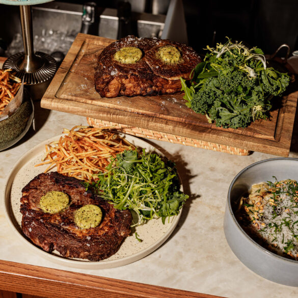Grilled ribeye steak with smoked Kampot pepper butter, wild porcini ravioles, and crispy string potatoes at Merci Marcel, Robertson Quay, Singapore.