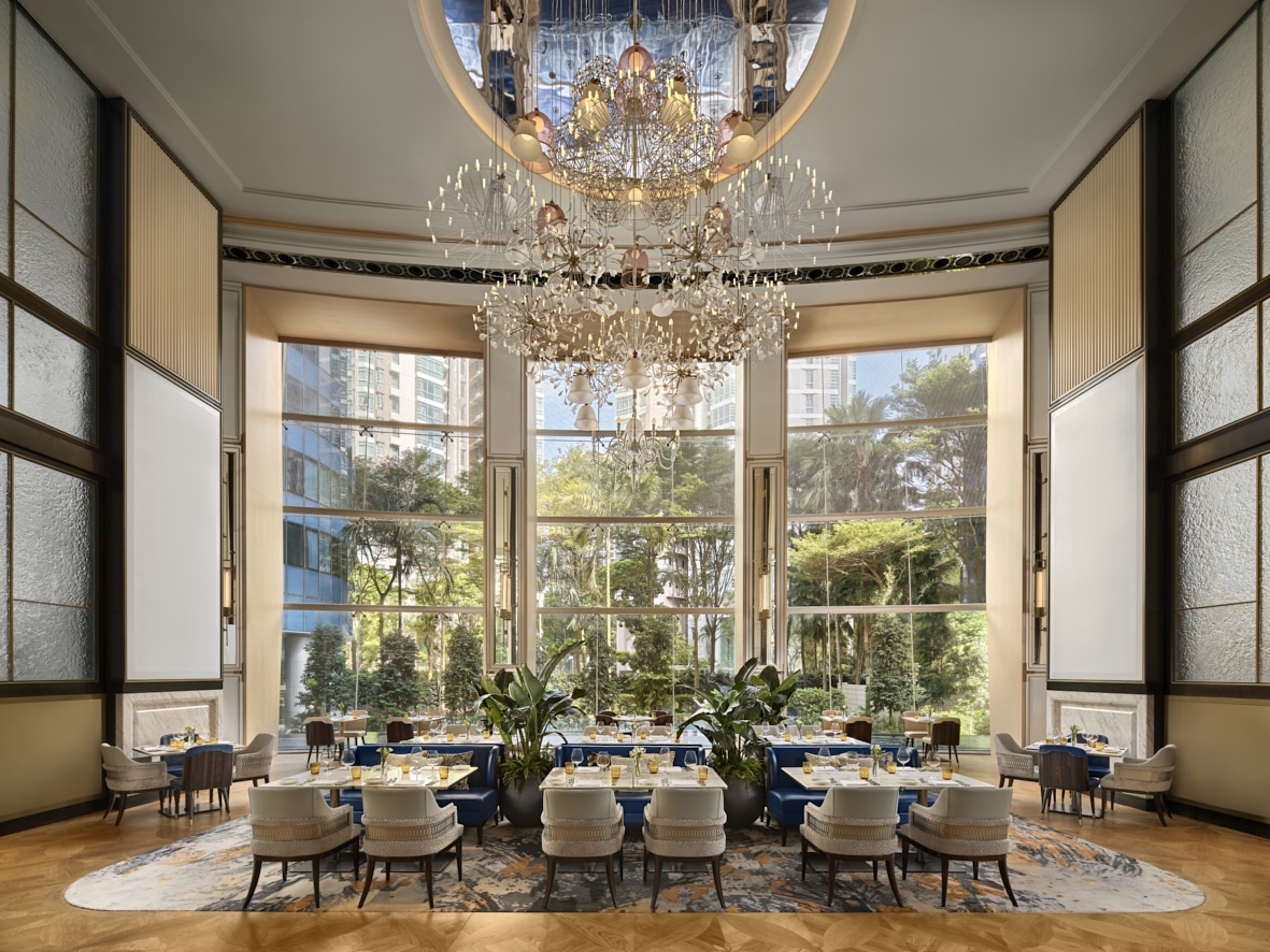 Elegant dining hall of Sophia at The St. Regis Singapore, featuring chandeliers, high ceilings, and modern Italian cuisine by Chef Angelo Sergio