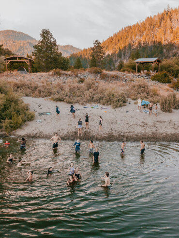 A dramatic view of towering redwood trees from below in a California state park, ideal for showcasing forest hikes, tree canopy camping, and nature retreats.