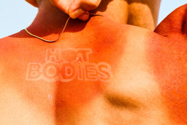 Sunburnt back with “HOT BODIES” tan line logo – promotional key visual for HOT BODIES Heatwear Exhibition in Singapore, exploring fashion and climate resilience.