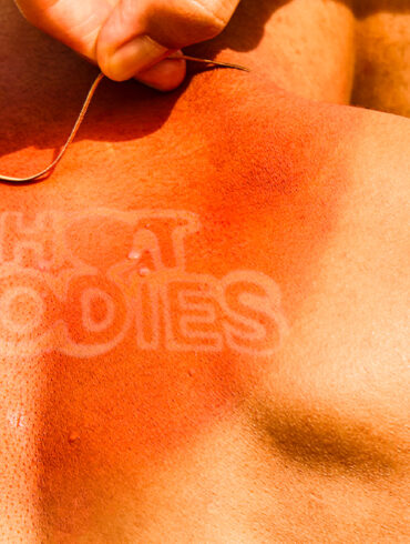 Sunburnt back with “HOT BODIES” tan line logo – promotional key visual for HOT BODIES Heatwear Exhibition in Singapore, exploring fashion and climate resilience.