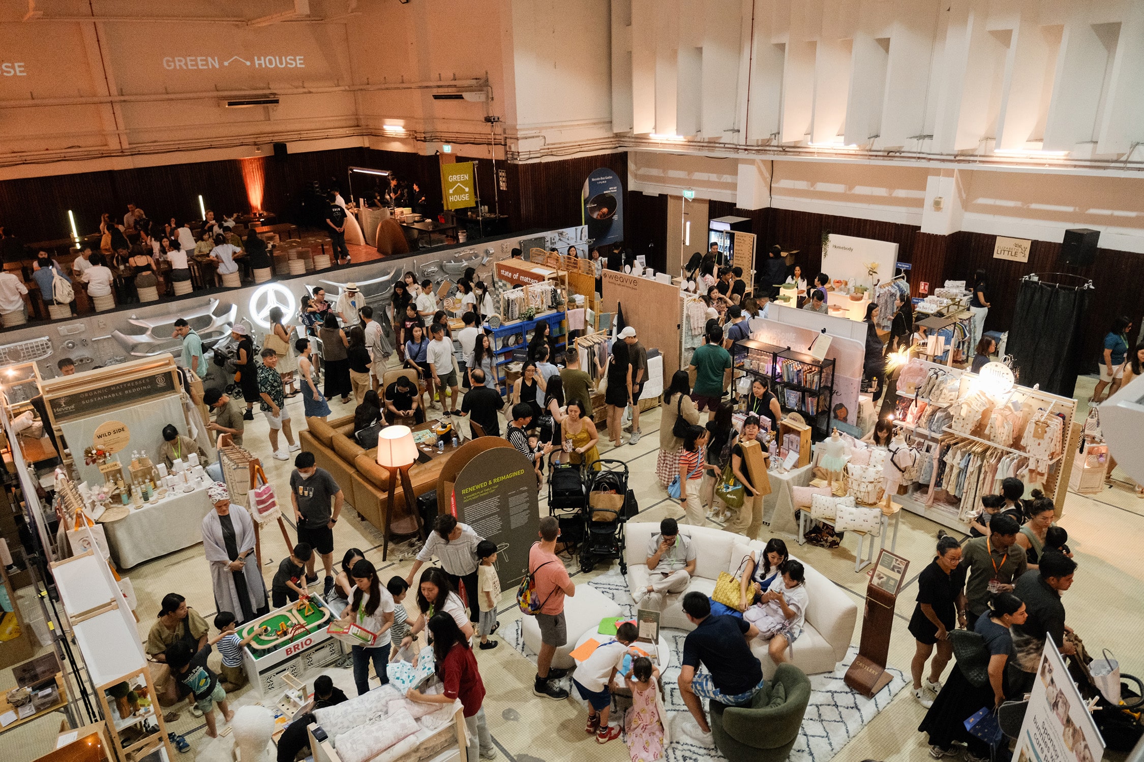 Crowds browsing sustainable lifestyle booths at GREEN-HOUSE HangOut, part of the Rainforest Festival at Mandai Rainforest Resort in Singapore.