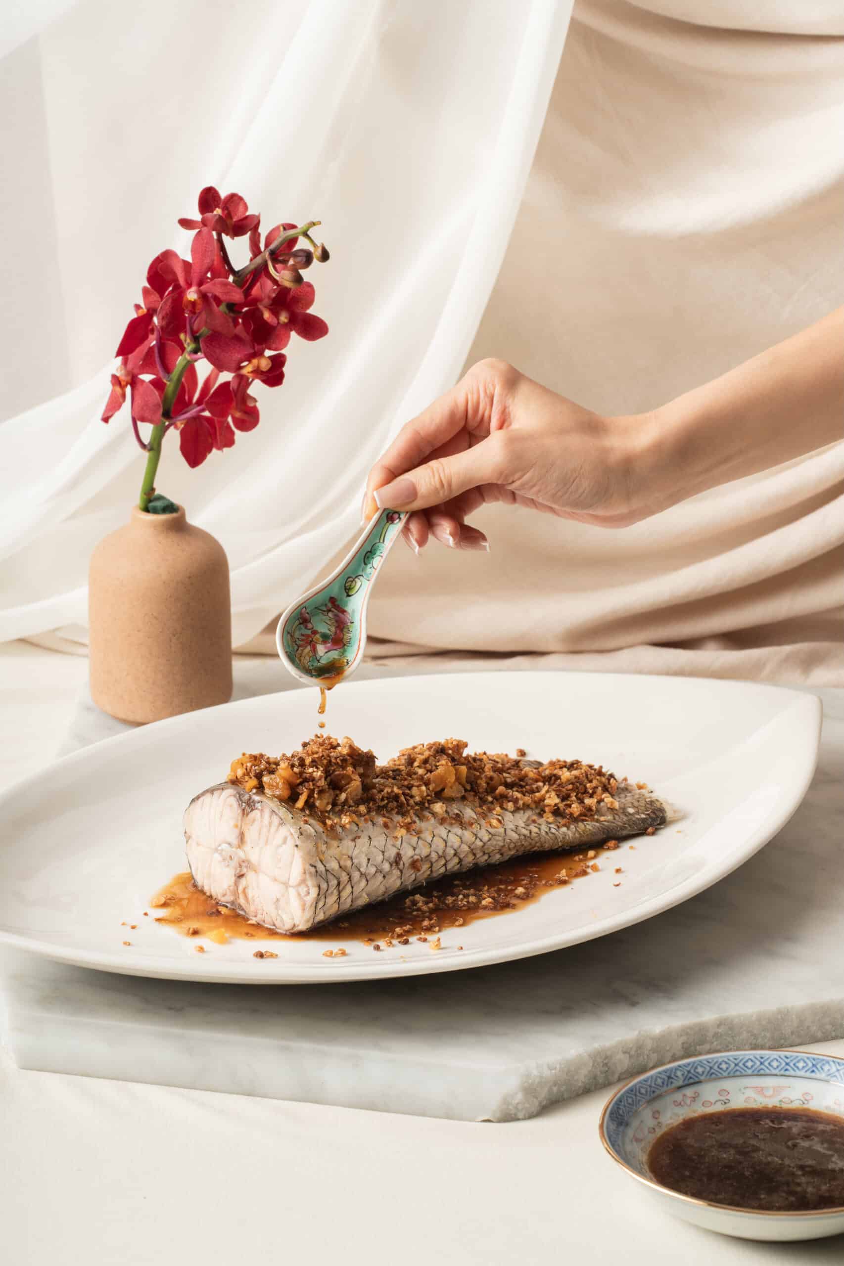 Heritage Eurasian-style steamed fish with soy sauce and chai poh from Gilmore & Damian D'Silva – a new restaurant at National Gallery Singapore.