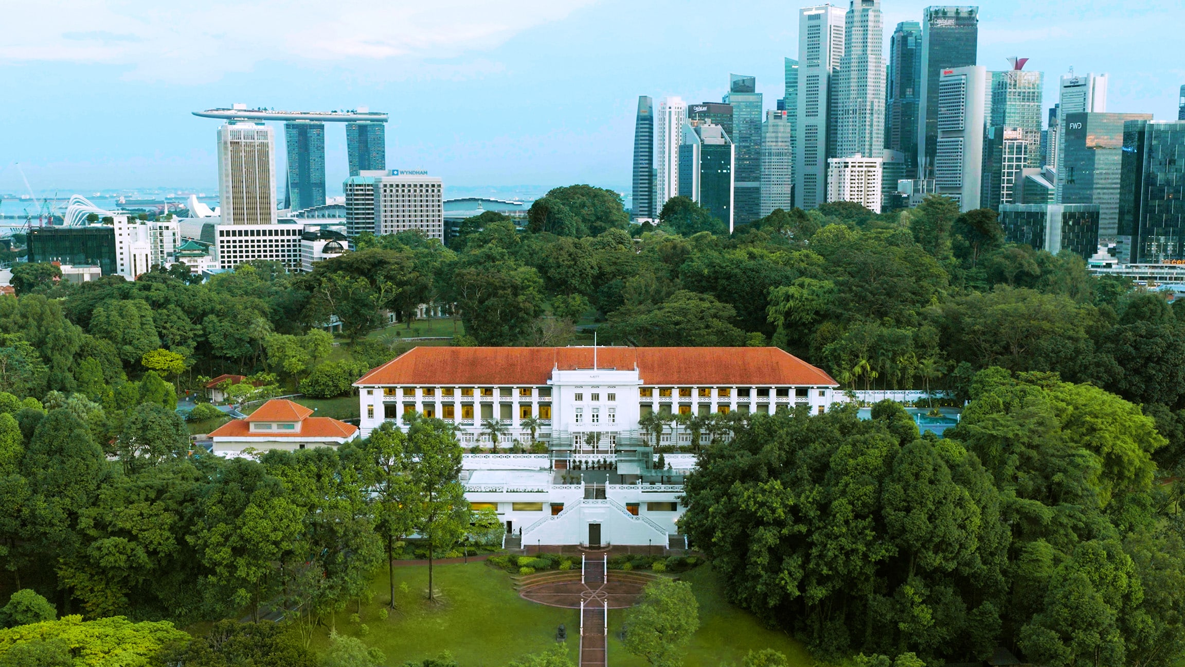 Aerial view of METT Singapore at Fort Canning Park with lush greenery and city skyline in the background, New Year’s Eve venue 2025