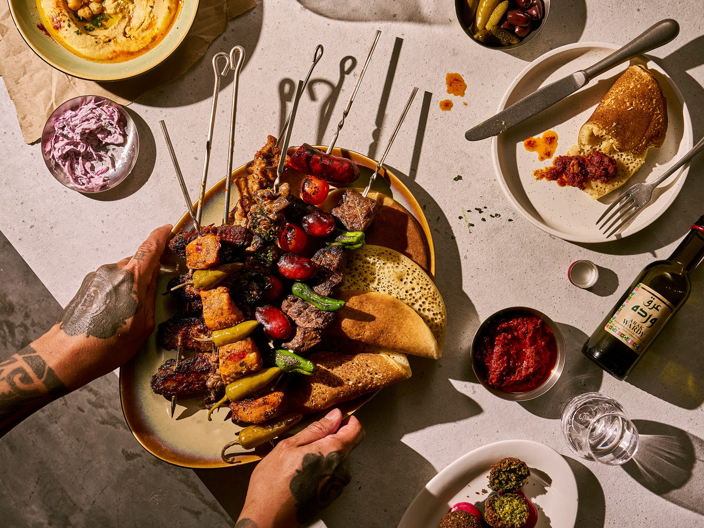 Charcoal-grilled skewers at STYXX Singapore, a modern grill bar on Teck Lim Road — with lamb, vegetables, and Middle Eastern dips like hummus and matbuha.