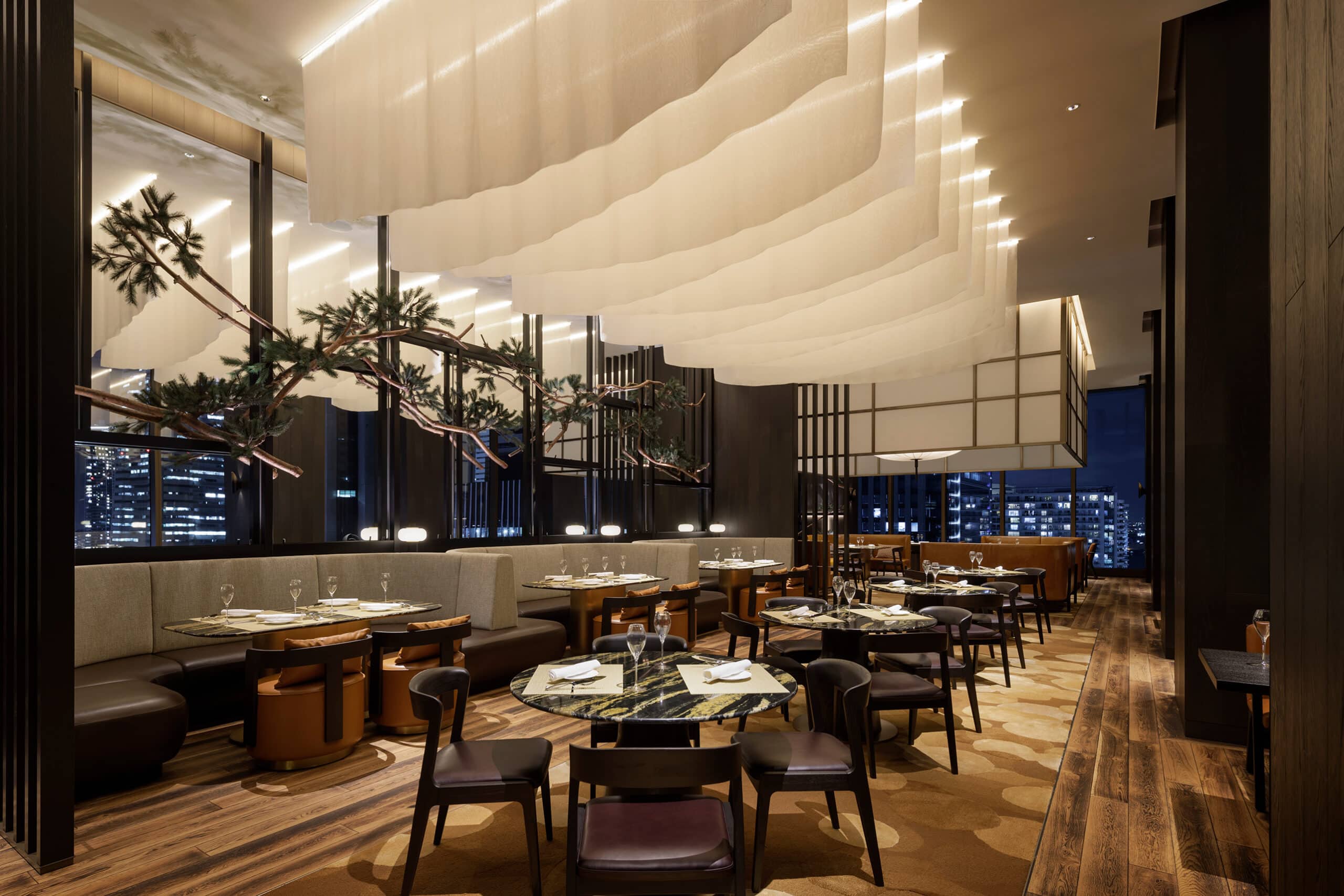 Iron Bay, the signature wood-fire restaurant at The Westin Yokohama, showcasing dramatic lighting and Japanese-modern interiors with skyline views.