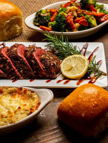 Home-style Christmas roast chicken surrounded by mashed sweet potatoes, cranberry sauce, and holiday tarts, showcasing comforting festive takeaway vibes.