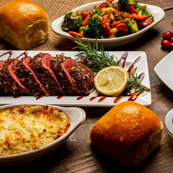 Home-style Christmas roast chicken surrounded by mashed sweet potatoes, cranberry sauce, and holiday tarts, showcasing comforting festive takeaway vibes.