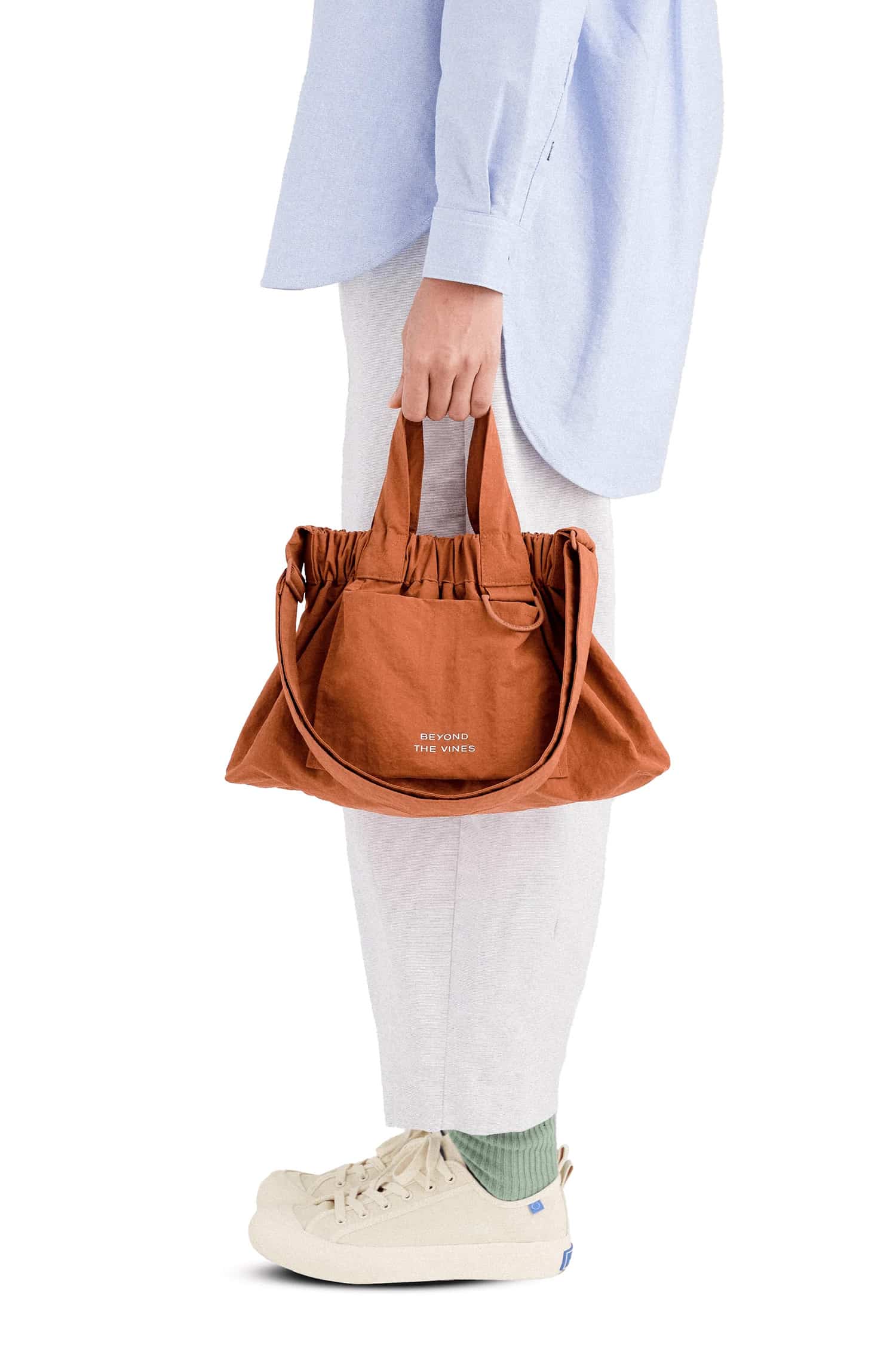 Compact terracotta dumpling bag by Beyond The Vines, a stylish and affordable gift for women under $100.