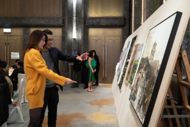 Guests engaging with contemporary artworks at Para Site’s 2025 Benefit Auction in Hong Kong, highlighting community connection and collector interest in emerging Asian artists.