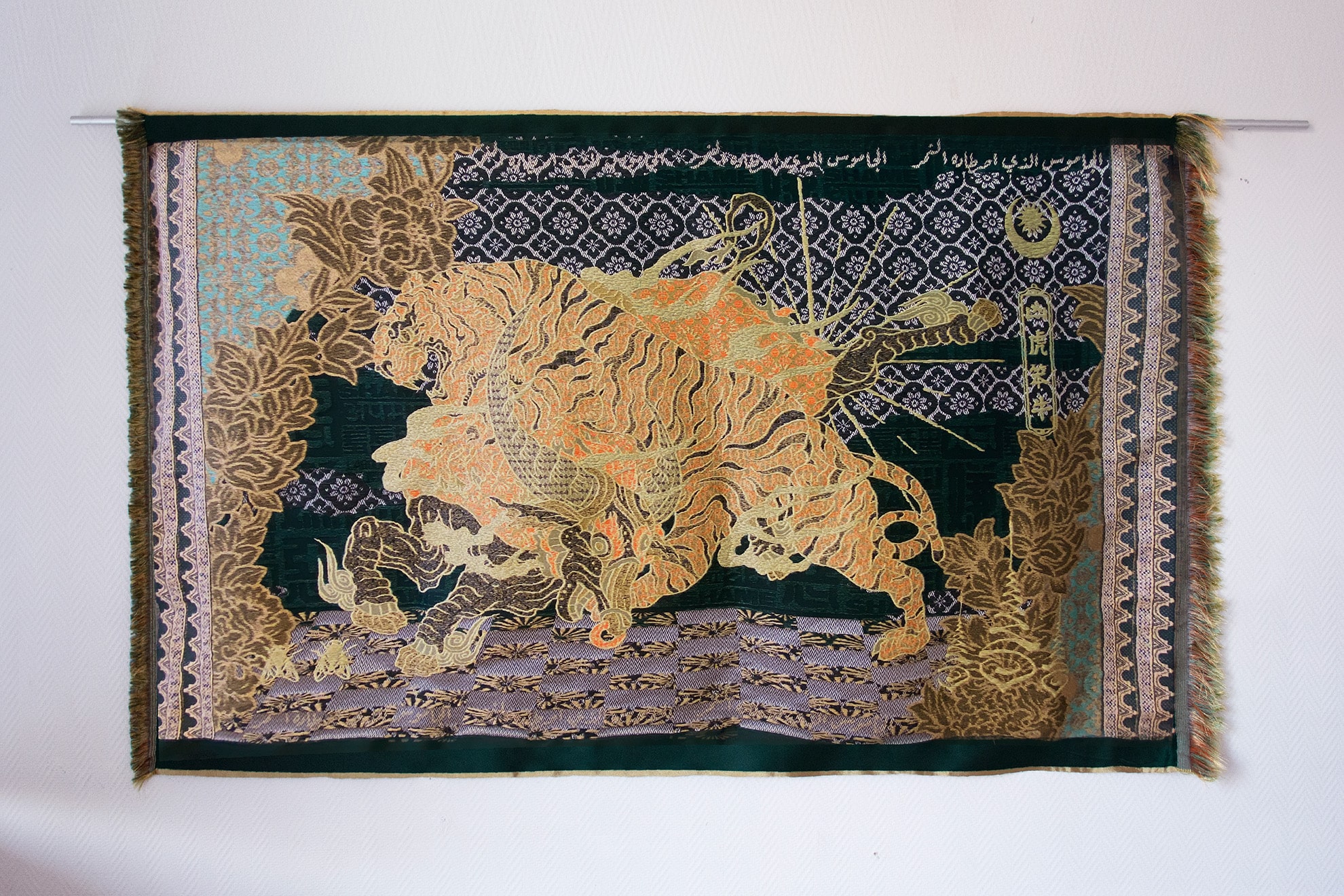 Textile artwork “Kerbau Ditangkap Harimau” (2025) by Marcos Kueh, shown at Para Site Hong Kong, depicting a tiger attacking a buffalo, woven from recycled PET yarns and referencing Southeast Asian folklore and contemporary art practices.