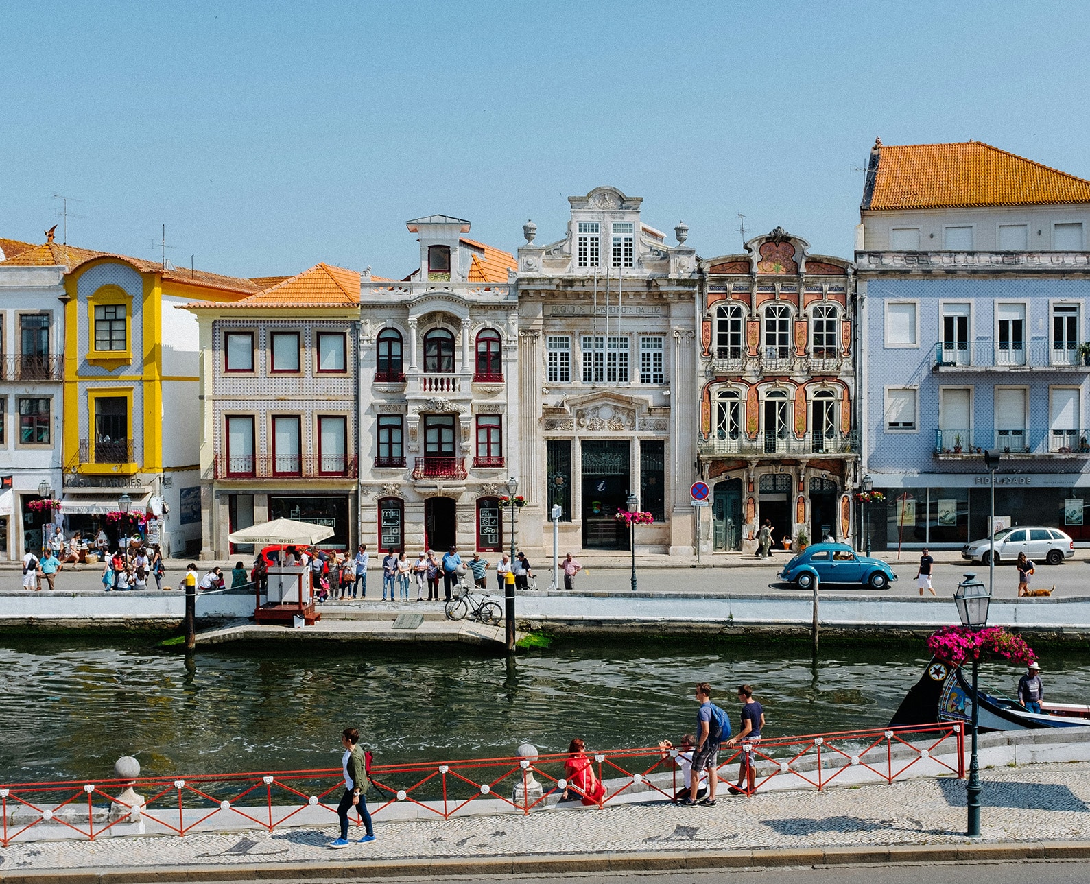 Vibrant Art Nouveau buildings along the canal in Aveiro, Portugal, often called the 'Venice of Portugal' — a must-stop on any scenic Portugal road trip.