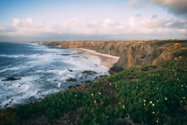 Dramatic cliffs and wild Atlantic coastline near Alentejo, Portugal, captured during golden hour — a breathtaking destination for road trippers.