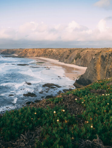 Dramatic cliffs and wild Atlantic coastline near Alentejo, Portugal, captured during golden hour — a breathtaking destination for road trippers.