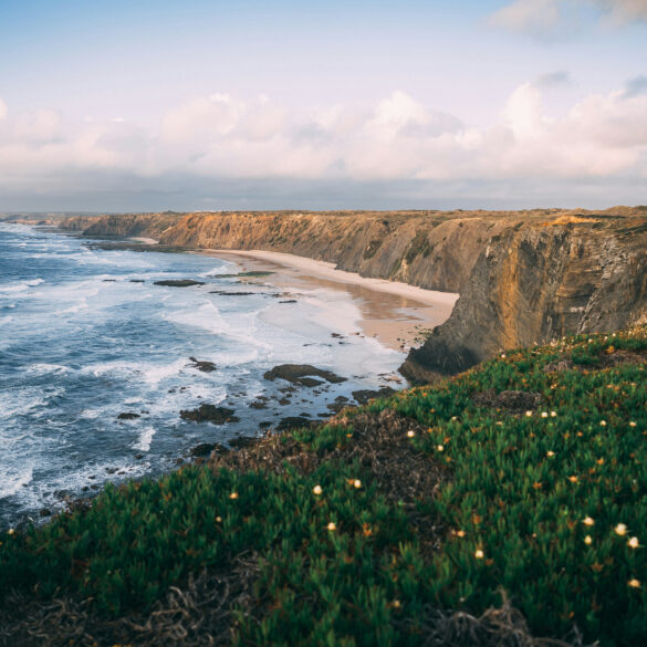 Dramatic cliffs and wild Atlantic coastline near Alentejo, Portugal, captured during golden hour — a breathtaking destination for road trippers.