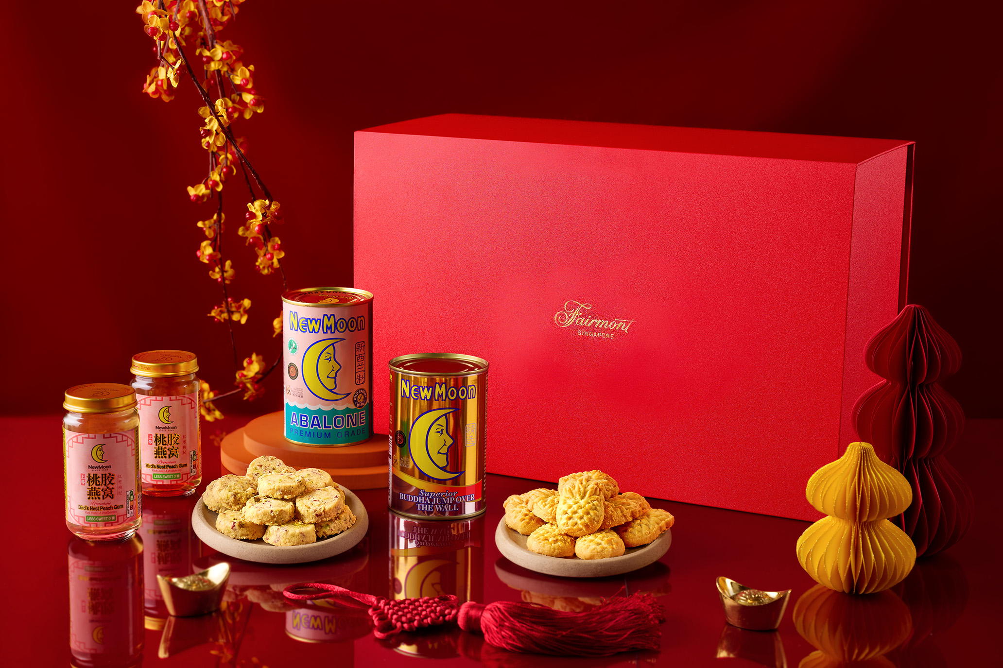 Fairmont Singapore Lunar New Year hamper featuring premium abalone, Buddha Jumps Over the Wall, festive cookies, and gift-ready packaging for home celebrations
