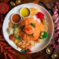 Salmon yu sheng takeaway from Greenwood Fish Market, featuring sliced salmon, fresh vegetables, and traditional lo hei condiments for Chinese New Year celebrations in Singapore