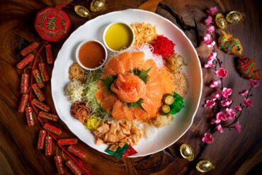Salmon yu sheng takeaway from Greenwood Fish Market, featuring sliced salmon, fresh vegetables, and traditional lo hei condiments for Chinese New Year celebrations in Singapore