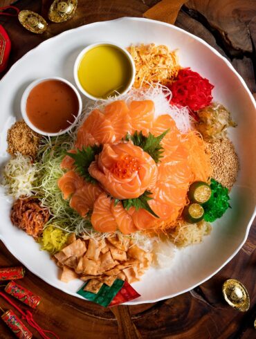 Salmon yu sheng takeaway from Greenwood Fish Market, featuring sliced salmon, fresh vegetables, and traditional lo hei condiments for Chinese New Year celebrations in Singapore