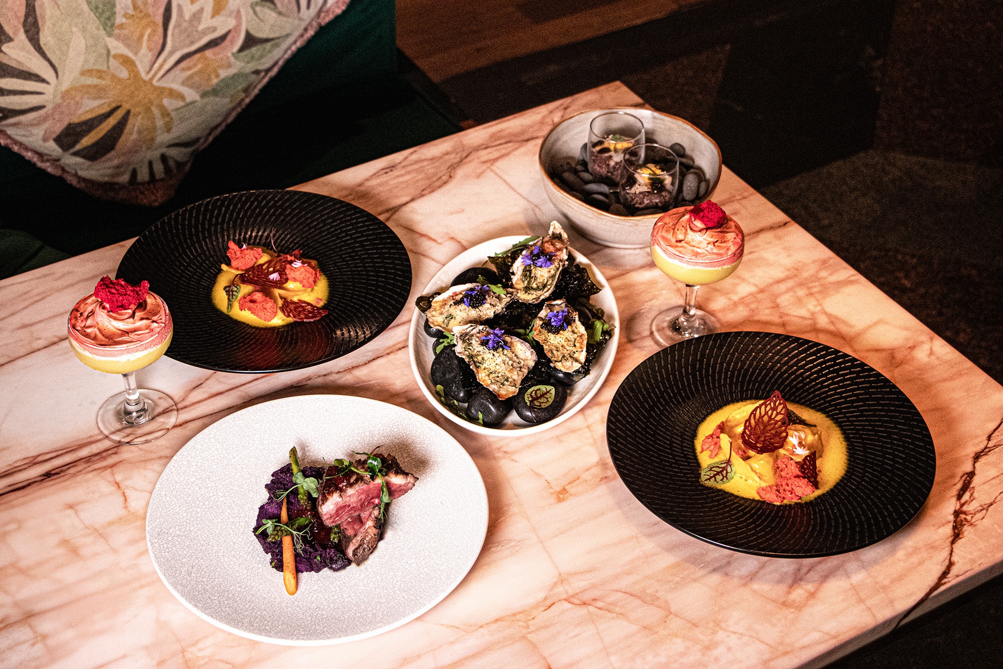 Valentine’s Day dinner spread at Publico Singapore featuring oysters, steak, desserts, and cocktails served on a marble table for a romantic dining experience in 2026.