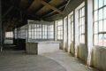 Sunlit industrial warehouse venue in Marvila, Lisbon, showcasing the raw architectural setting hosting Parallel Society, a cross-disciplinary cultural event in Portugal.