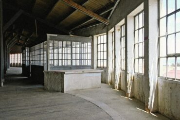 Sunlit industrial warehouse venue in Marvila, Lisbon, showcasing the raw architectural setting hosting Parallel Society, a cross-disciplinary cultural event in Portugal.