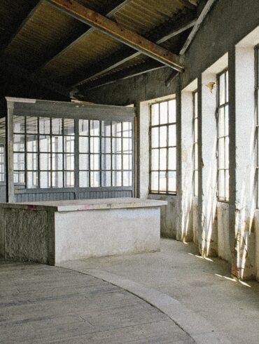 Sunlit industrial warehouse venue in Marvila, Lisbon, showcasing the raw architectural setting hosting Parallel Society, a cross-disciplinary cultural event in Portugal.