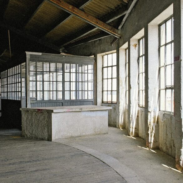 Sunlit industrial warehouse venue in Marvila, Lisbon, showcasing the raw architectural setting hosting Parallel Society, a cross-disciplinary cultural event in Portugal.