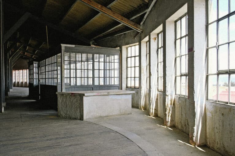 Sunlit industrial warehouse venue in Marvila, Lisbon, showcasing the raw architectural setting hosting Parallel Society, a cross-disciplinary cultural event in Portugal.