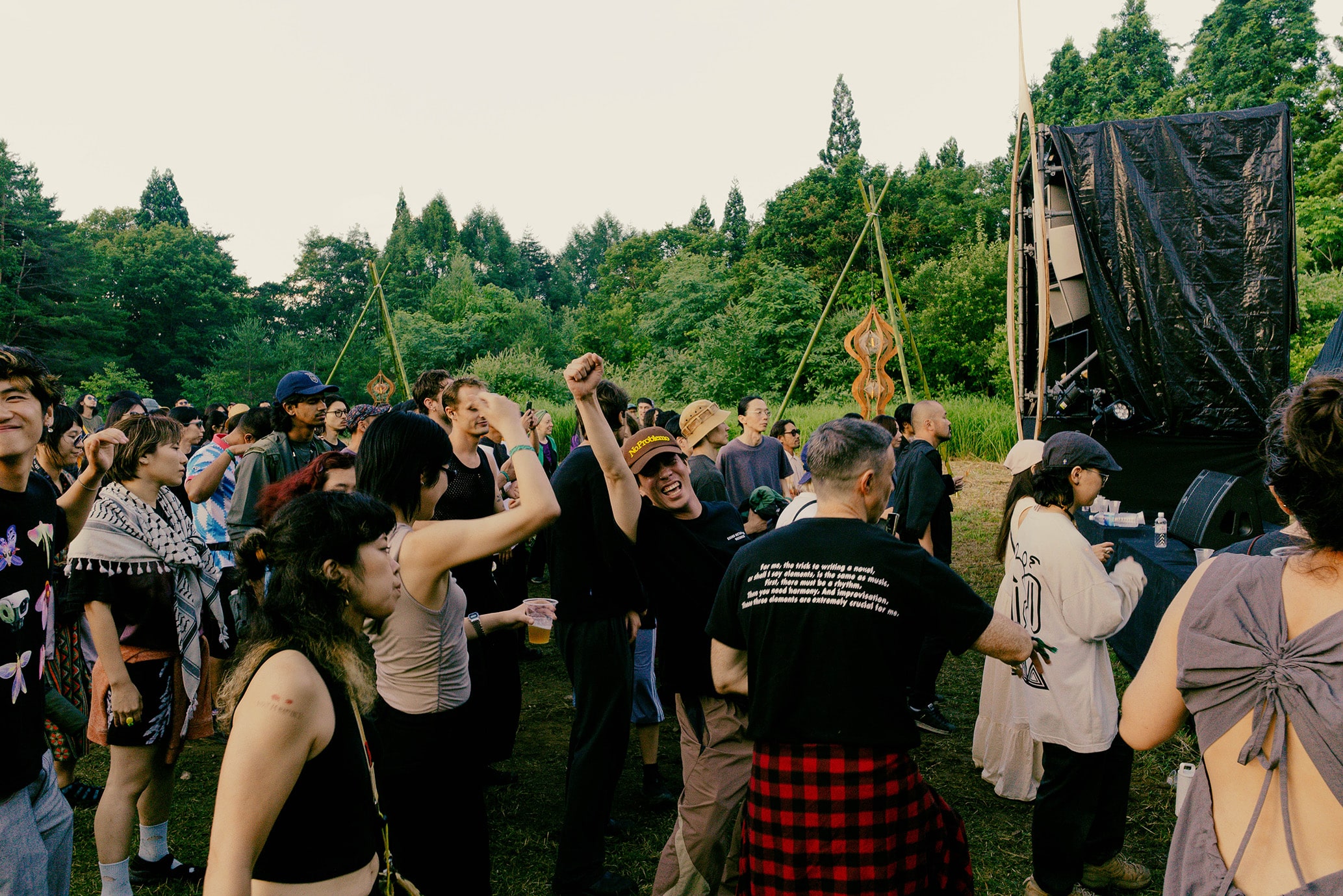 Festival-goers dancing during the day at rural 2025, Japan’s immersive open-air techno festival in Fukushima's forested mountains