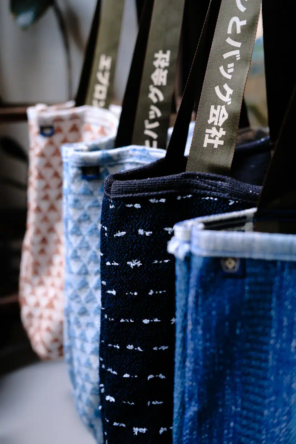 Handmade tote bag by FIN Crafted Goods crafted from surplus Christopher Farr fabric with geometric blue pattern and deadstock straps, showcasing sustainable design made in Singapore.