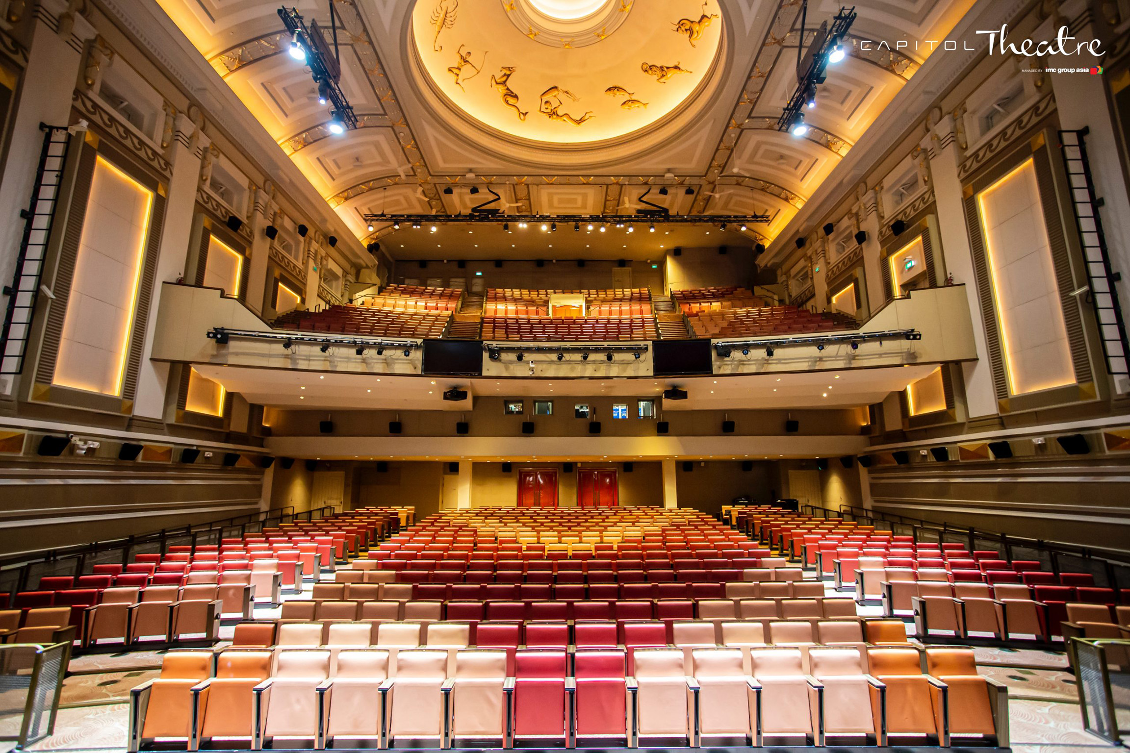 Restored interior of Capitol Theatre Singapore showing the stage, seating, and ornate ceiling details.