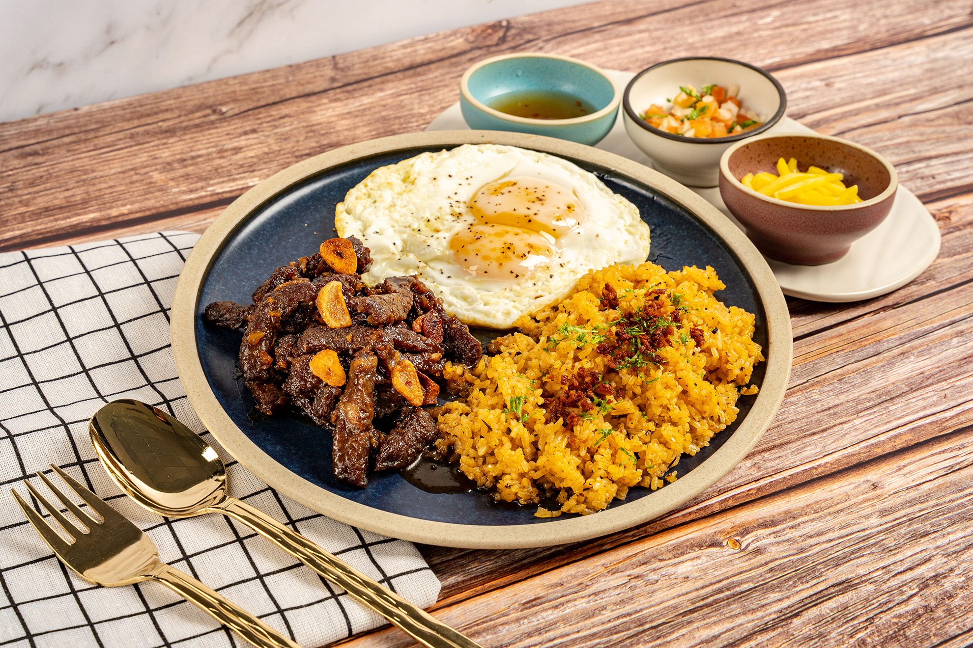 Filipino-style Angus beef tapa with garlic rice and sunny-side-up eggs at Mary Grace Singapore