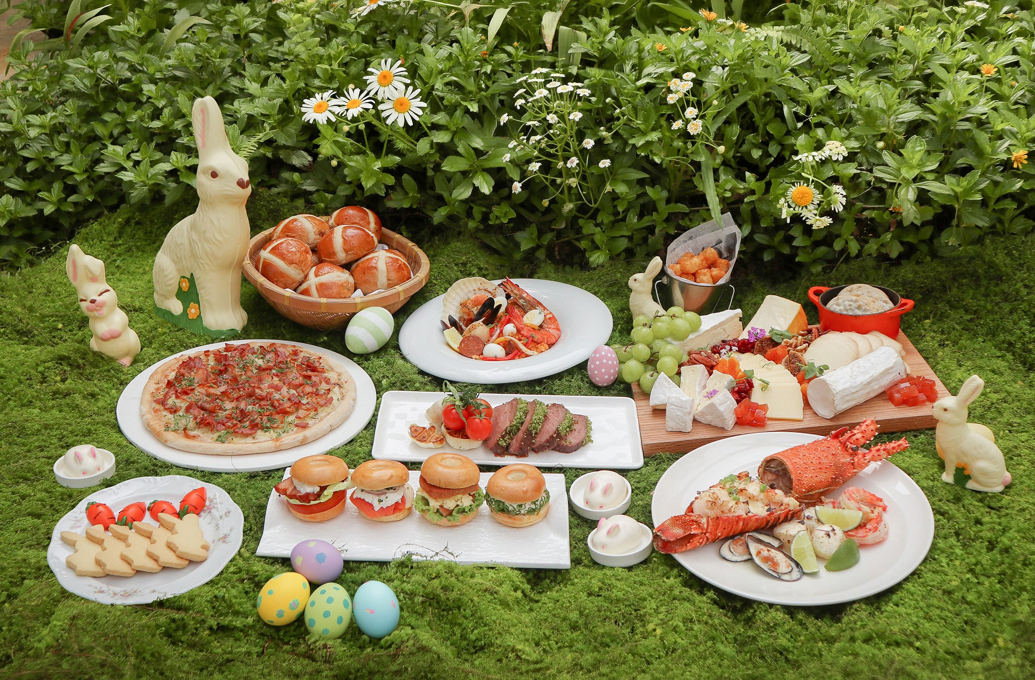 Easter brunch buffet at Goodwood Park Hotel featuring lobster, cheeses, bagels, roast meats, seafood, and festive Easter decorations.
