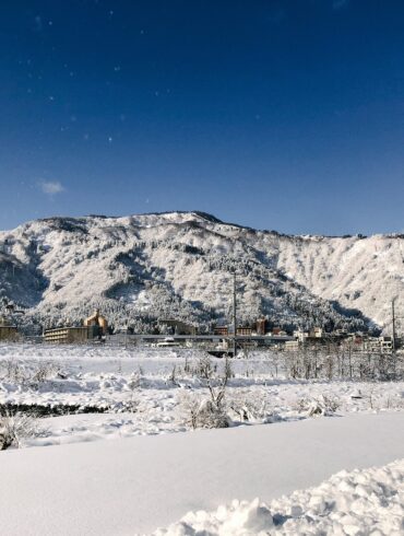 Snow-covered mountains and townscape of Yuzawa Onsen in Niigata, Japan’s Snow Country near Tokyo.