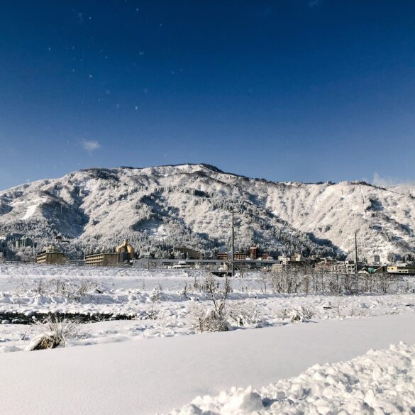 Snow-covered mountains and townscape of Yuzawa Onsen in Niigata, Japan’s Snow Country near Tokyo.