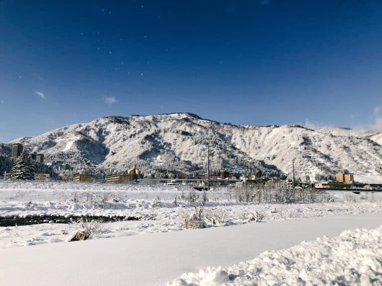 Snow-covered mountains and townscape of Yuzawa Onsen in Niigata, Japan’s Snow Country near Tokyo.