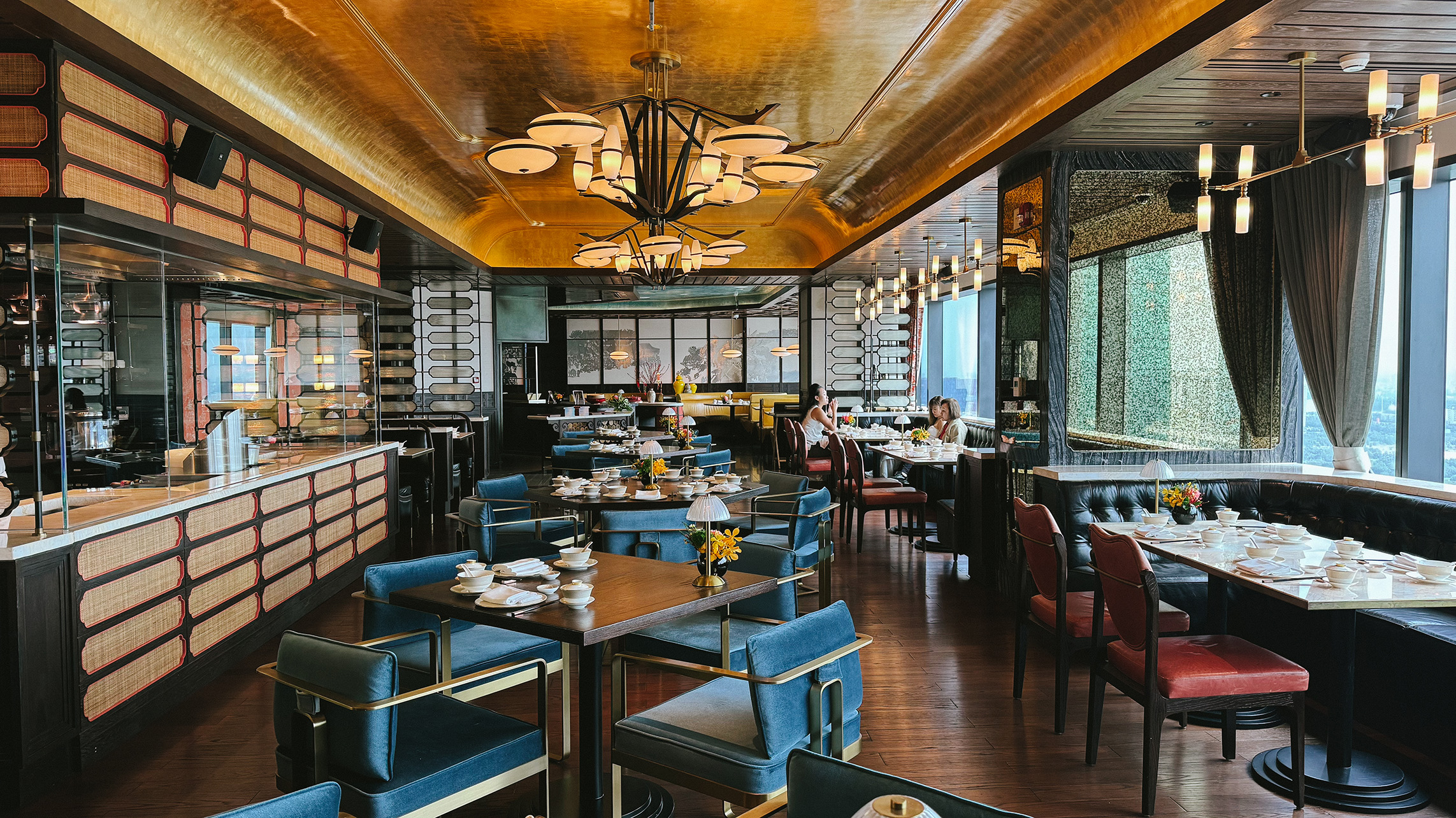 Dining room interior of Residence Eleven restaurant at Hilton Saigon with city views