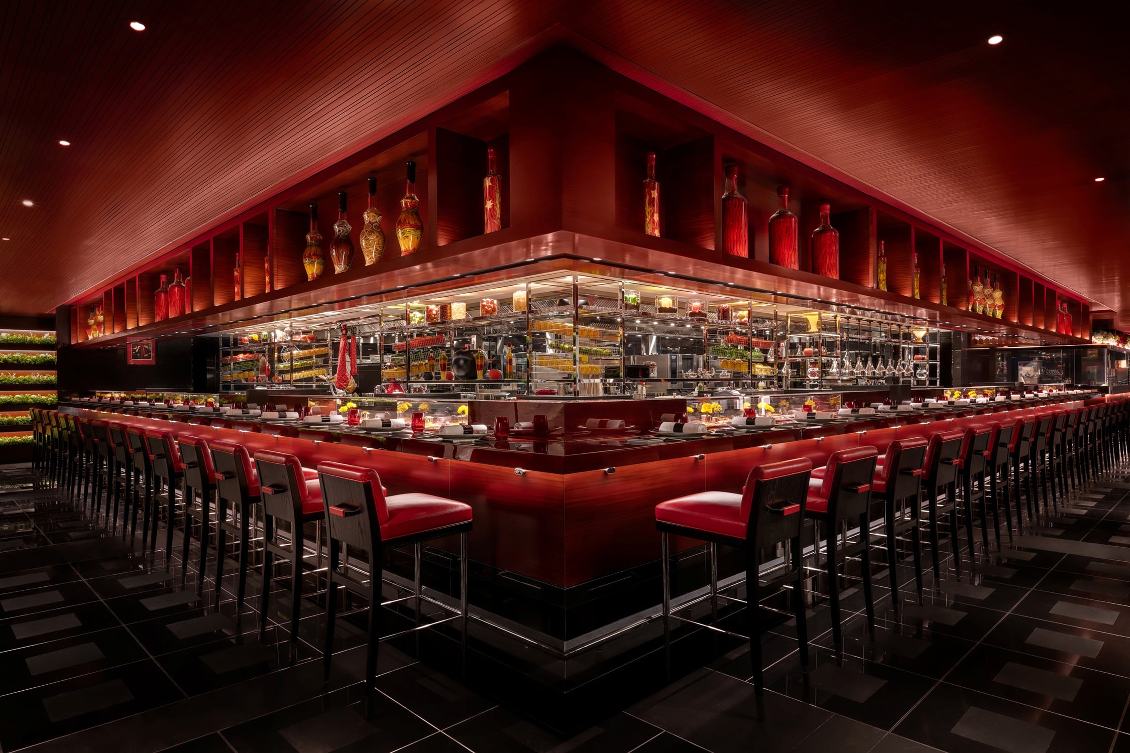 L’Atelier de Joël Robuchon Hong Kong open kitchen counter with red and black interior