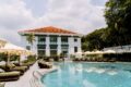 Madison House Singapore pool with heritage colonial building backdrop and poolside cabanas at Fort Canning