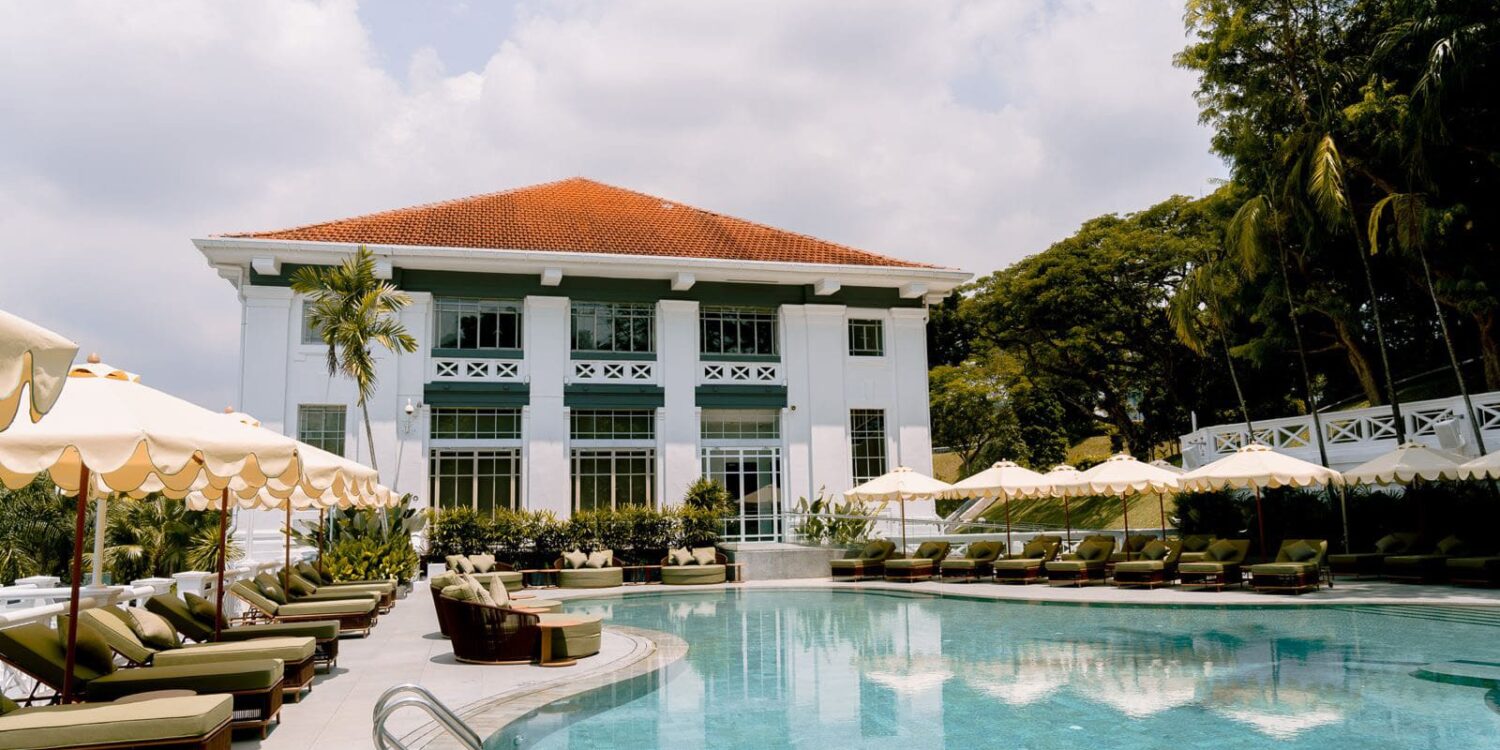 Madison House Singapore pool with heritage colonial building backdrop and poolside cabanas at Fort Canning