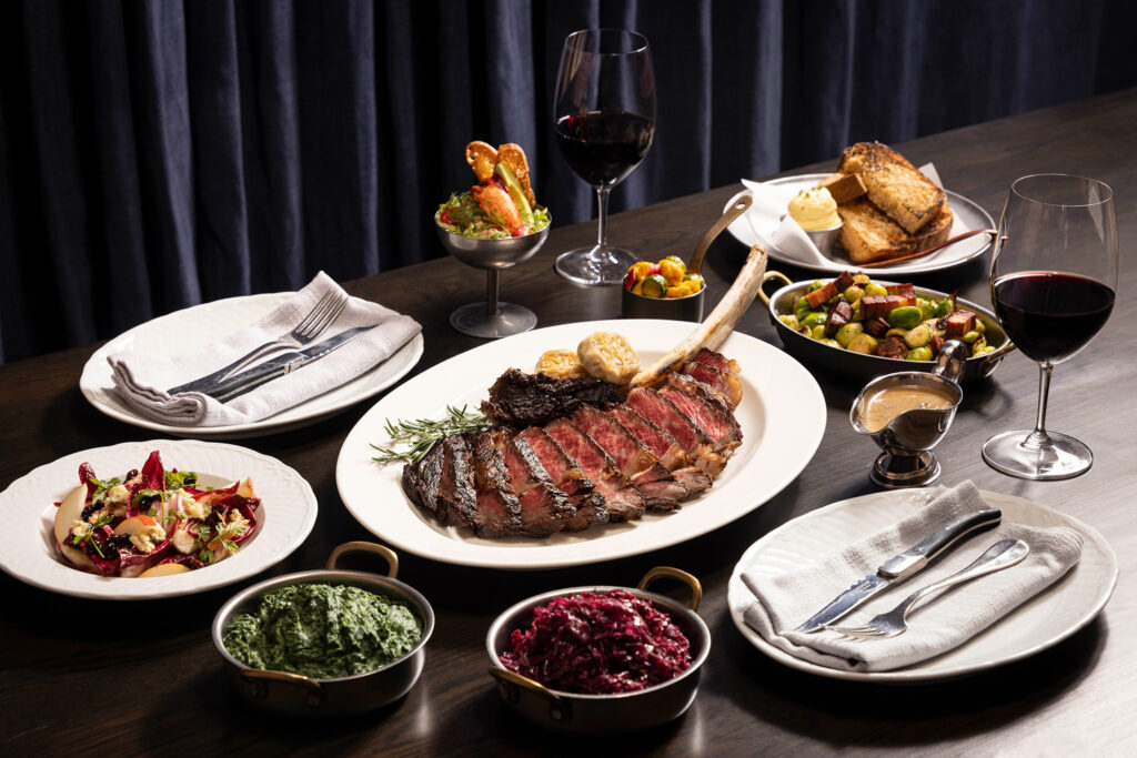 Tomahawk steak with classic sides and red wine at Stags Head Steakhouse Singapore