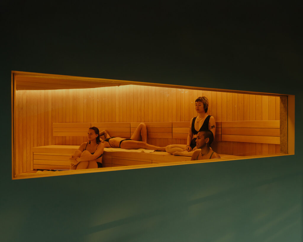 Mixed-gender guests relaxing inside the Finnish sauna at Nowhere Baths, Dempsey Hill, Singapore